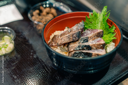 Photography KOCHI, JAPAN - may 2 2025 Seared bonito tataki served on a plate
