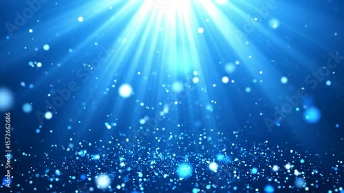 Abstract blue background with light rays and particles