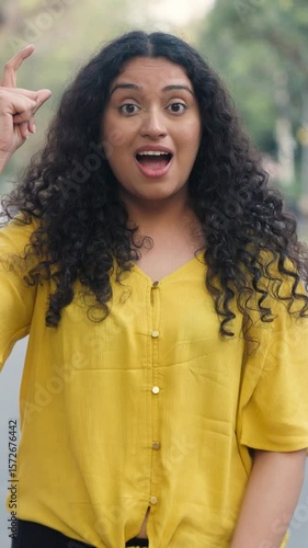 Indian Girl with Curly Hair Getting an Idea