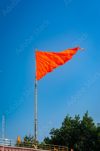 Hindu flag fluttering against a clear blue sky