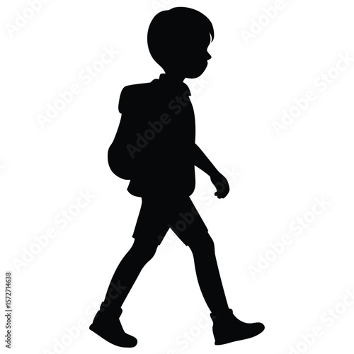 Silhouette of a schoolboy walking side view with backpack