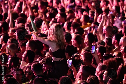 Photography Young woman crowd surfing and dancing at music festival