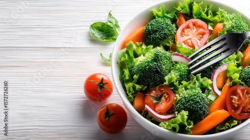 Vibrant Vegetable Salad: A fresh and healthy vegetable salad in a bowl, featuring broccoli, carrots, tomatoes, lettuce, and red onion. A fork rests on top, ready to take a bite.