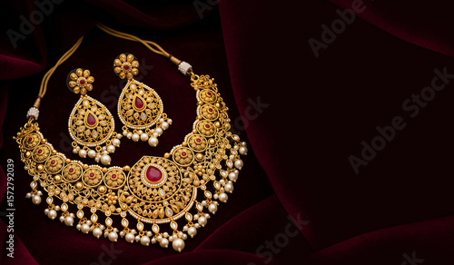 A luxurious gold jewellery earrings. Dark red Background | Akshaya Tritiya Design