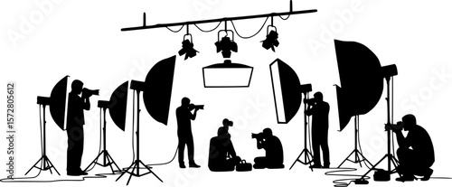 Silhouette of two photographers with studio lighting equipment in a photography session setting on white 