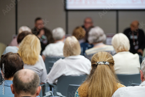 Wallpaper Mural Audience at an event showing the back of seated attendees in an indoor venue. Torontodigital.ca