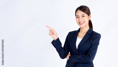 テキストスペースを指差している若い女性。募集や案内のビジネスシーンをイメージ。