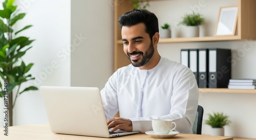 Successfull middle eastern man using laptop at work