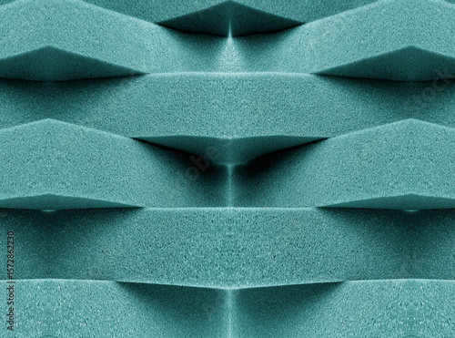 green foam material arranged transversely. overlapping pile	

