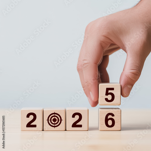 Wallpaper Mural A close-up photograph of a hand placing a wooden cube with the number 5 on it, next to other numbered cubes. Torontodigital.ca
