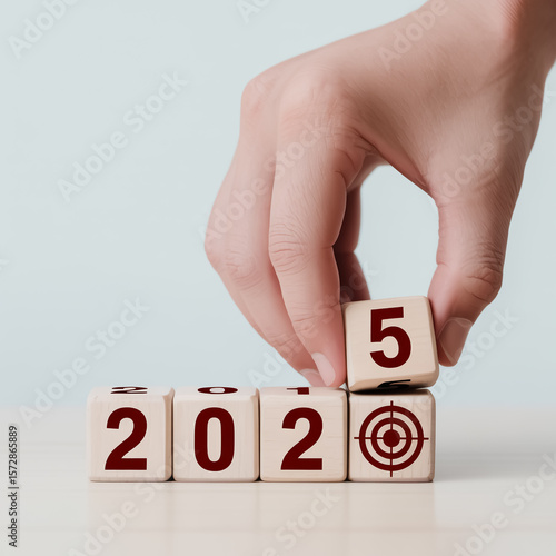 Wallpaper Mural A close-up photograph of a hand placing a wooden cube with the number 5 on it, next to other numbered cubes. Torontodigital.ca