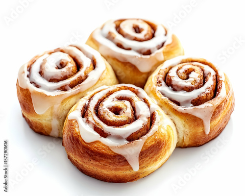 Delicious and freshly baked cinnamon rolls with sweet icing on a white surface
