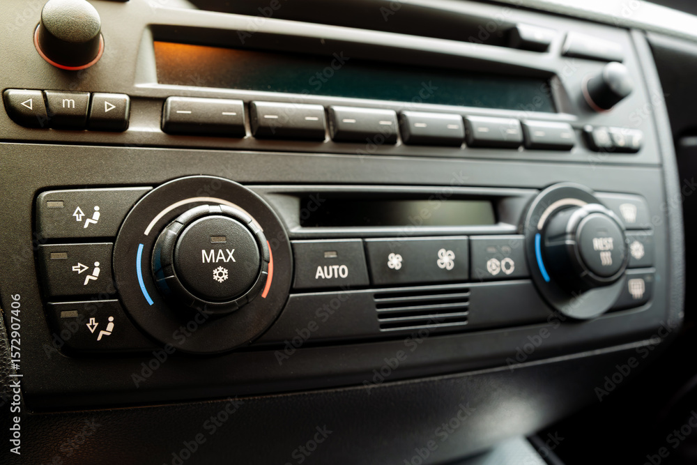 Fototapeta premium Car dashboard AC control panel with physical button and small LCD.