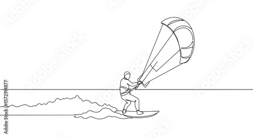 Kiteboarder riding waves with a parachute against the ocean