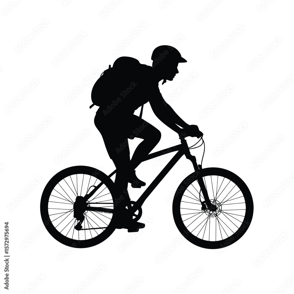 Obraz premium Silhouette of a cyclist with a backpack riding a mountain bike