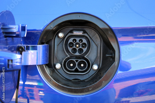 Blue Electric Vehicle Charging Port. Electric vehicle charging port on the rear fender. Electric vehicle charging ports are open to receive electricity. Electric vehicle is ready to charge.