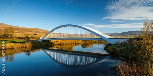 A modern minimalist bridge spanning a quiet river