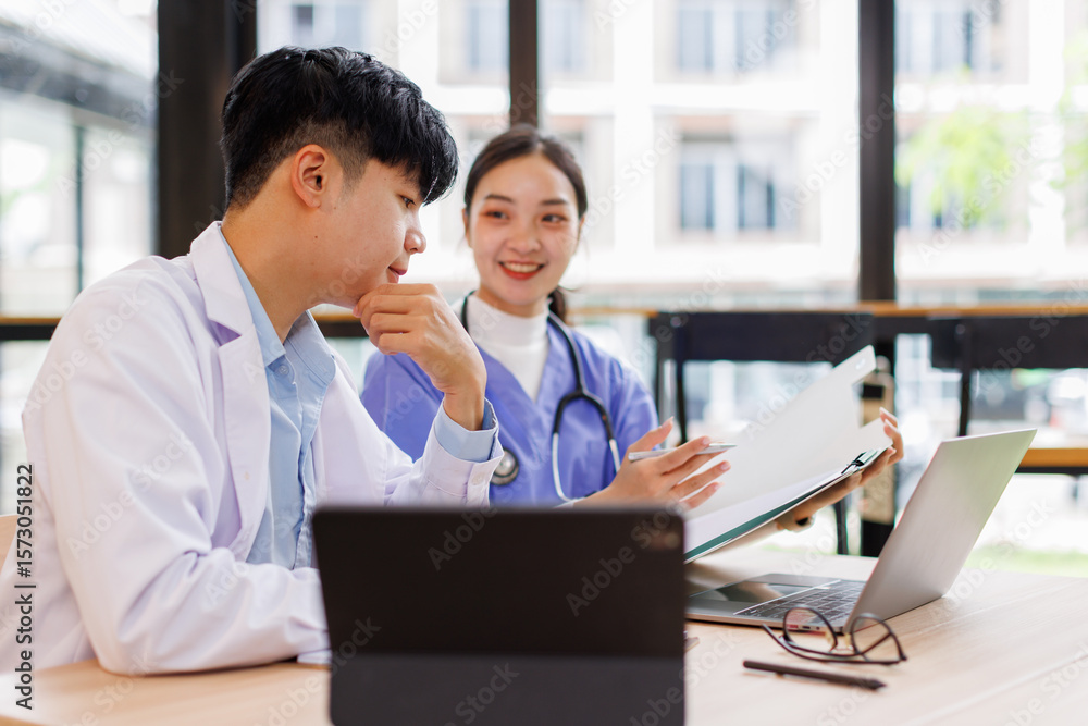 Fototapeta premium Medical staff meeting, Doctors and nurse woman work on laptop in day healthcare, planning 