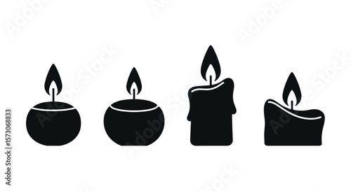 Four different shaped burning candles isolated on a white background showing wax drips and flames