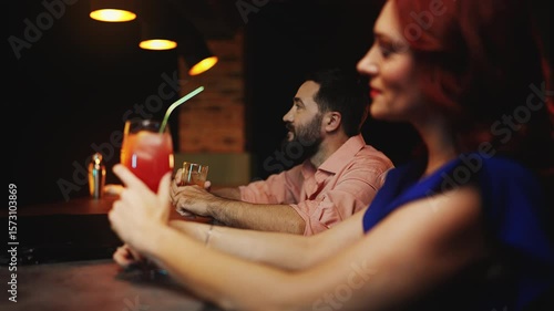 Shy man awkwardly trying to talk with pretty woman at bar counter, failed date