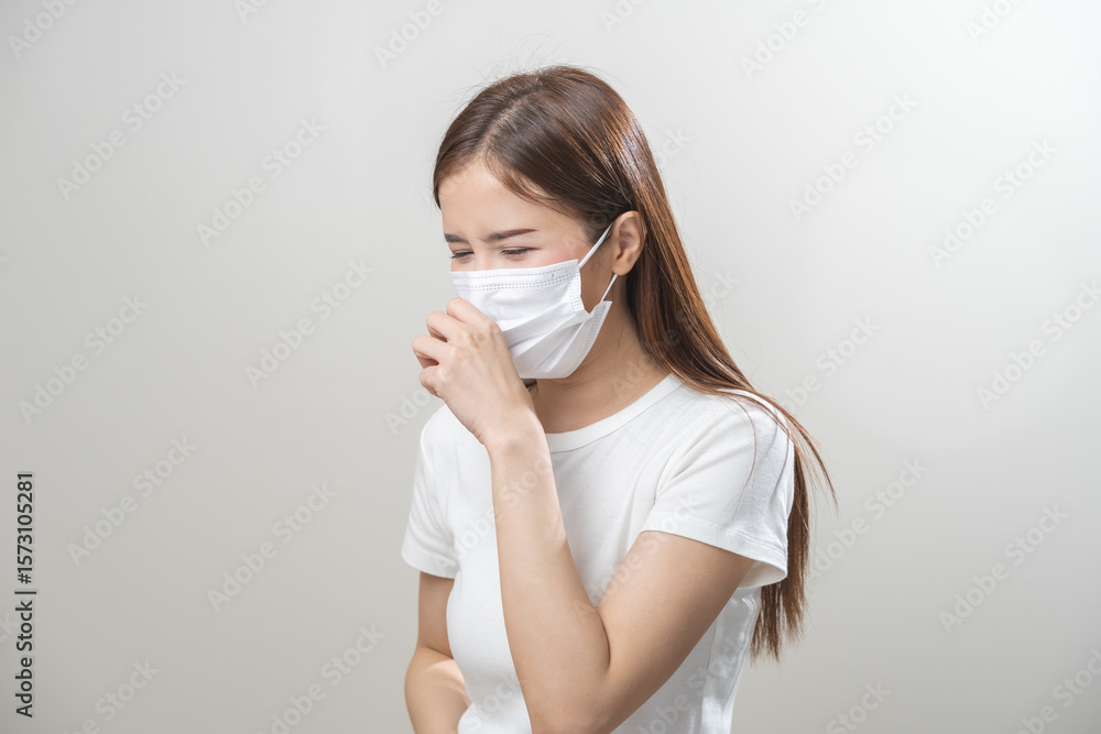 Unhealthy sickness, unwell asian young woman wearing mask coughing, have sore throat, suffering symptom cough feeling bad and healthcare of air pollution and dust, PM2.5 isolated white background. Unhealthy sickness, unwell asian young woman wearing mask coughing, have sore throat, suffering symptom cough feeling bad and healthcare of air pollution and dust, PM2.5 isolated white background.