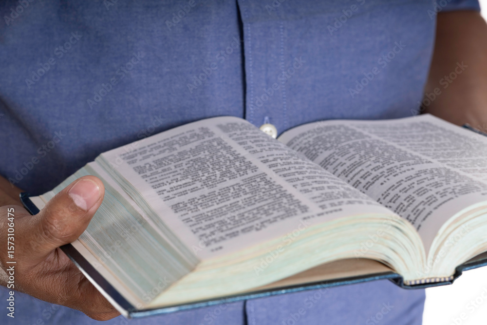 Fototapeta premium Person reading an open book for education and knowledge concept.
