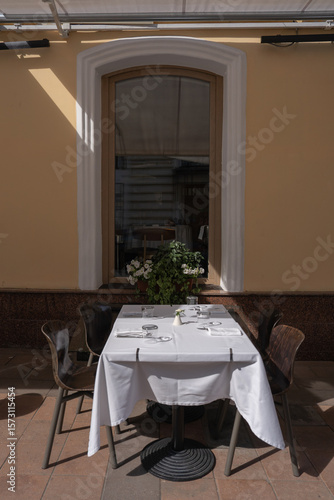 A Charming Outdoor Dining Setup Featuring an Elegant Table and Inviting Ambiance