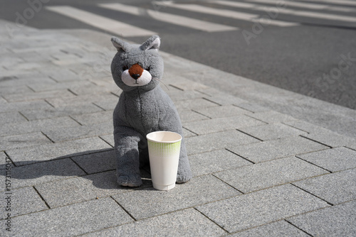 This charming and adorable plush wolf is sitting comfortably with a delightful coffee cup