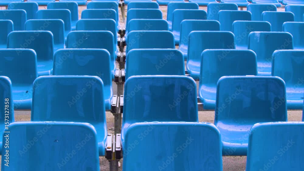 Rows of neat blue seats for an outdoor performance. Rows of bright blue seats line the venue, ready to accommodate an enthusiastic audience for a spectacular show. Rows of neat blue seats for an outdoor performance. Rows of bright blue seats line the venue, ready to accommodate an enthusiastic audience for a spectacular show.