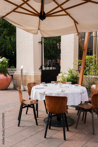 An Elegant Outdoor Dining Setup Featuring Stylish Umbrella and Comfortable Chairs
