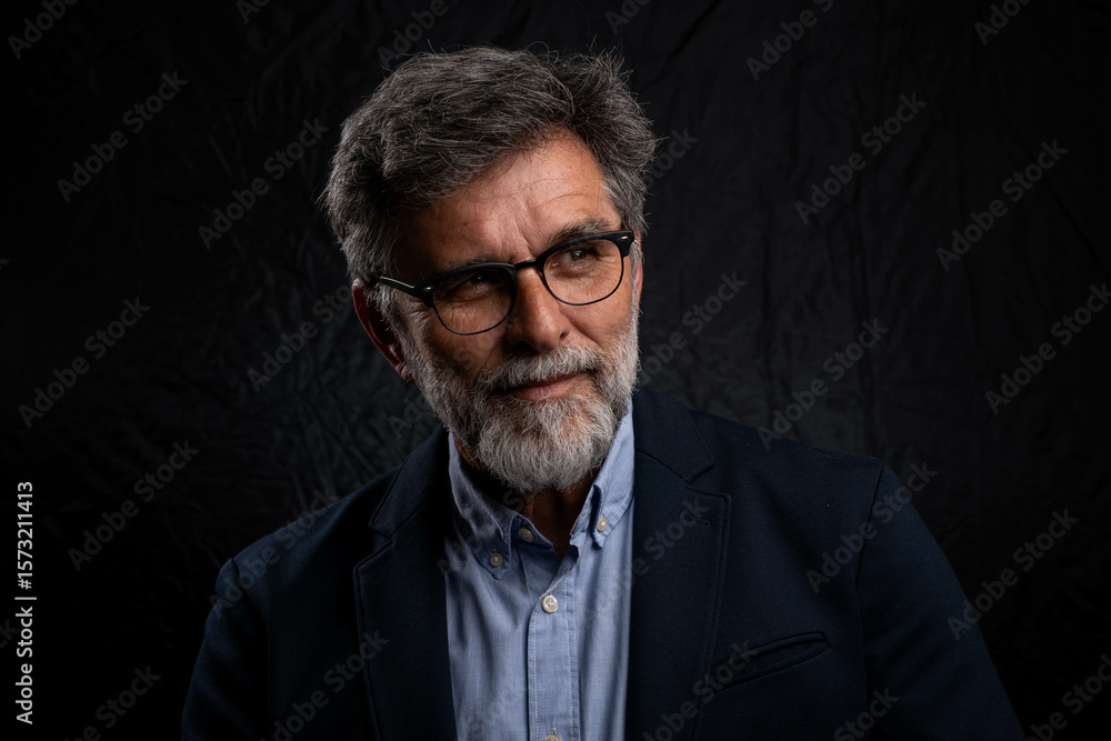 Portrait of handsome man in a studio on a dark background. Handsome man posing. Middle-aged good looking man posing in front of a black background with copy space Portrait of handsome man in a studio on a dark background. Handsome man posing. Middle-aged good looking man posing in front of a black background with copy space
