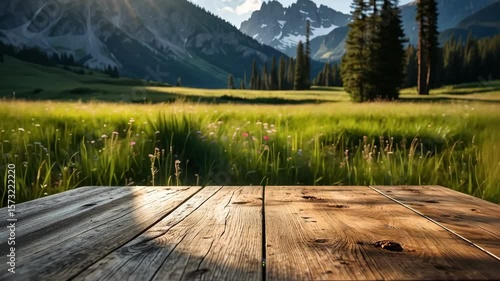 Wooden table with green meadow landscape and mountain backdrop, natural light, scenery background, table top, mountain, landscape, nature, wooden.