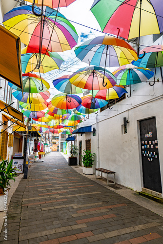 Colourful rainbow of umbrellas shade a laneway off Armenian St in George Town's heritage area.