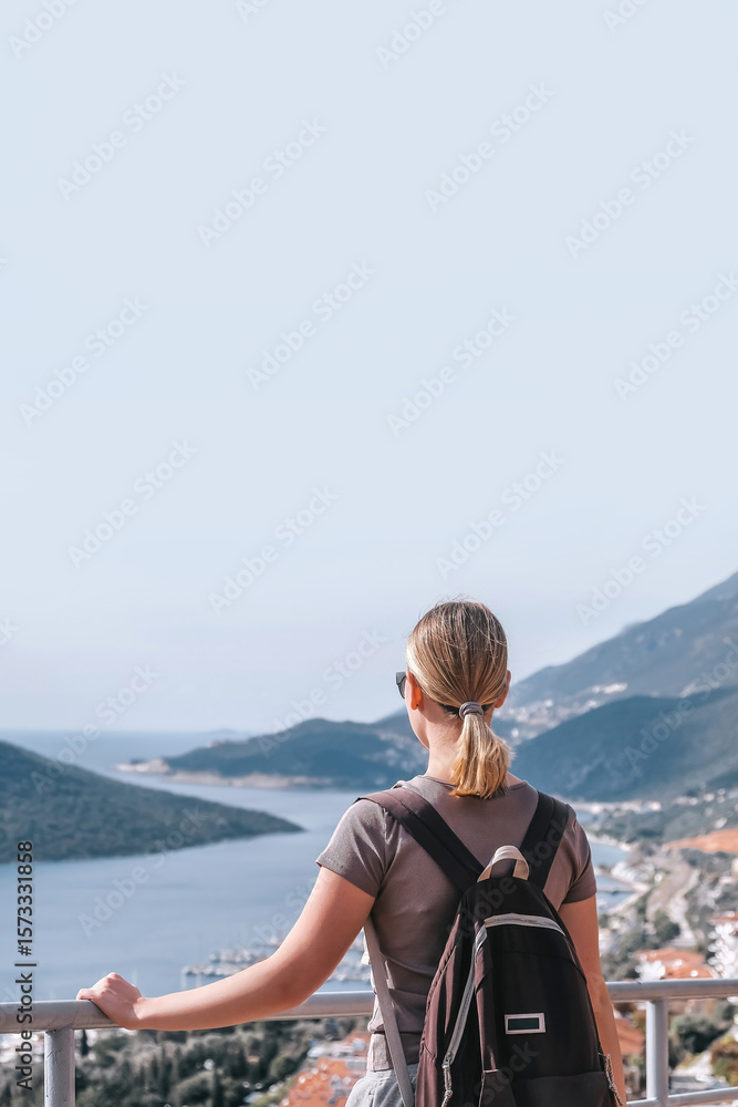 Fototapeta premium ourney, young woman embarks solo journey, middle breathtaking mountain panorama. Embracing self-care digital nomad lifestyle, freedom, adventure and personal growth