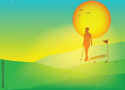 Golfer walking on sunny golf course at sunset