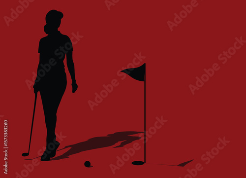 Golfer walking on the green towards the hole with putter