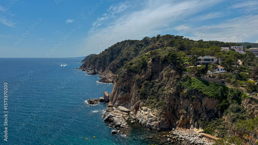 Fototapeta premium Scenic view of the Mediterranean Sea and the coastal town of Tossa de Mar in Catalonia, Spain. Historic architecture and natural beauty by the seaside.