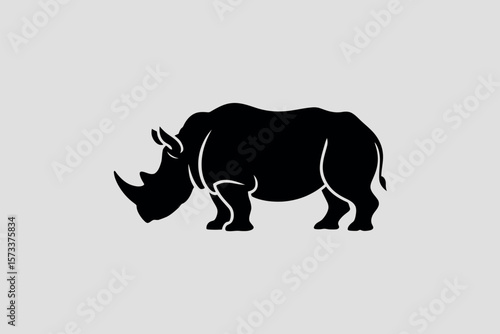 Strong Black Silhouette of a Rhinoceros Standing Proudly Against a Light Gray Background Depicting Wildlife and Nature Conservation in a Minimalist Style