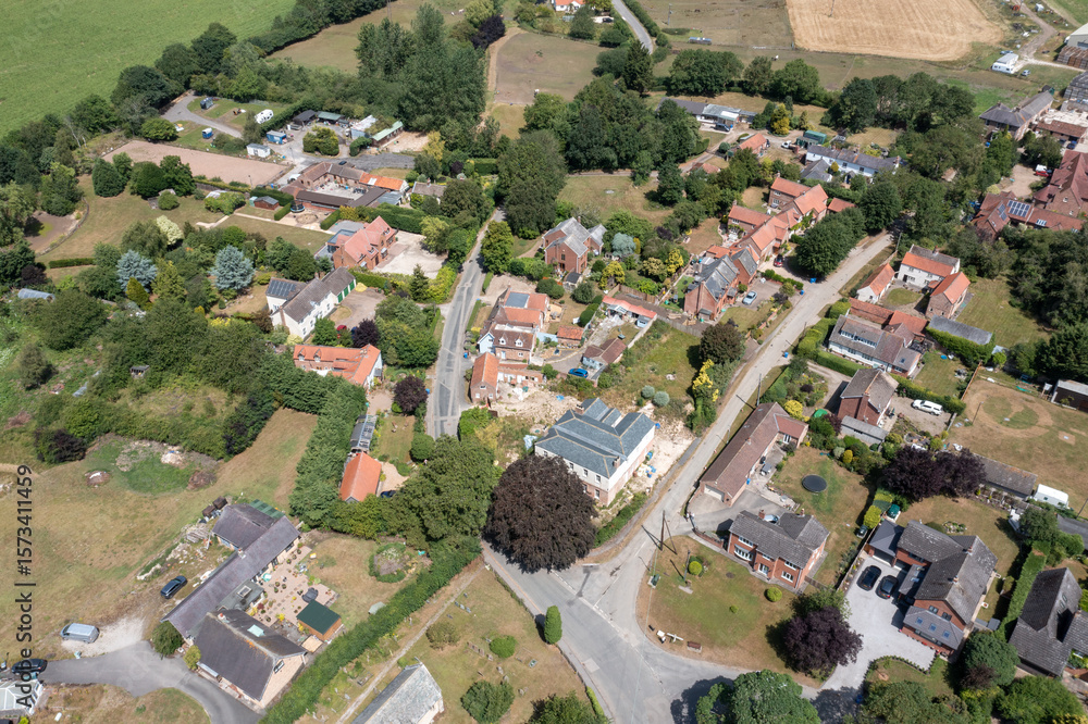 Fototapeta premium Aerial drone photo of the beautiful village of Burnby in the East Riding of Yorkshire, near York in the UK showing the quant little village from above on a sunny day in the summer time