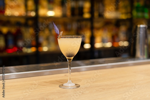 sour cocktail drink with ice cubes. Pisco sour alcohol cocktail on blur background surface.