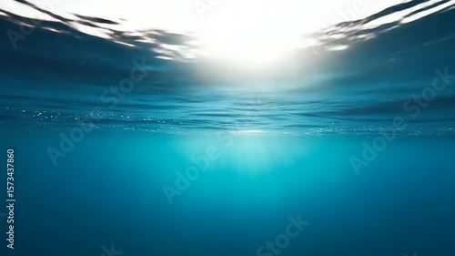 Sunlight filters into deep ocean waters A vast expanse of blue stretches upwards towards shimmering light dancing on the water s surface tranquility prevails