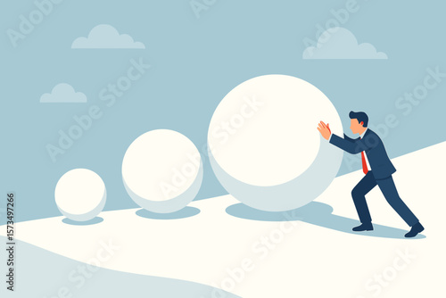 Businessman rolling large snowball up hill, snowball effect concept, financial growth risk, investment mistake, small actions build up, business progress metaphor