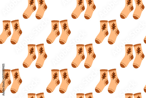 Cozy fall seamless pattern with soft peach socks decorated with seasonal leaf design