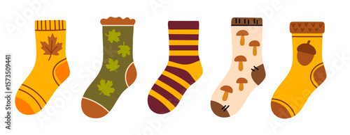 Set of colorful cozy socks decorated with seasonal elements like leaves, mushrooms, stripes and acorns