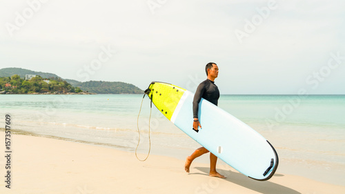 Photography Confidence Asian man in sportswear enjoy water sports surfing at the sea on summer beach holiday vacation