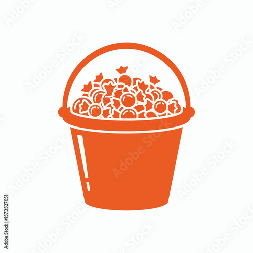 An orange silhouette of a bucket filled with candy set against a white background