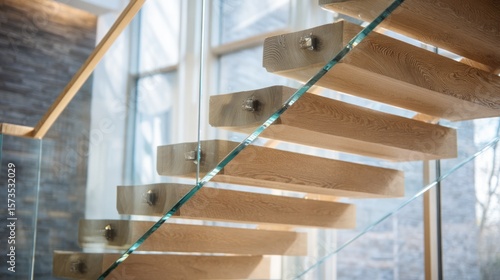 Modern, light-filled staircase with glass and wood treads