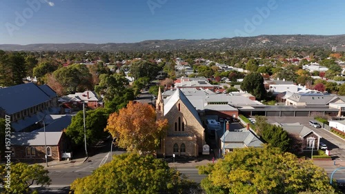 Wallpaper Mural Unley Uniting Church, South Adelaide, South Australia, Jun 3, 2025: 4K Aerial Footage in Autumn Featuring Historic Stone Church, Colourful Trees, Parklands, and Residential Suburb with Charming Houses Torontodigital.ca
