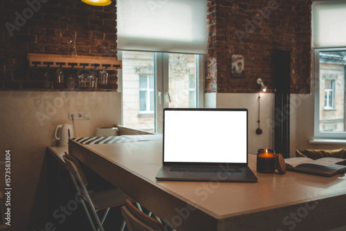 Wallpaper Mural Laptop, burning candle and open planner on table in a bright loft-style living room with brick walls, mustard armchair and large windows letting in daylight Torontodigital.ca