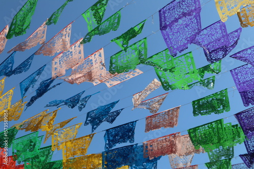 Colorful papel picado traditional mexican colorful banners blowing in the wind in rosarito mexico